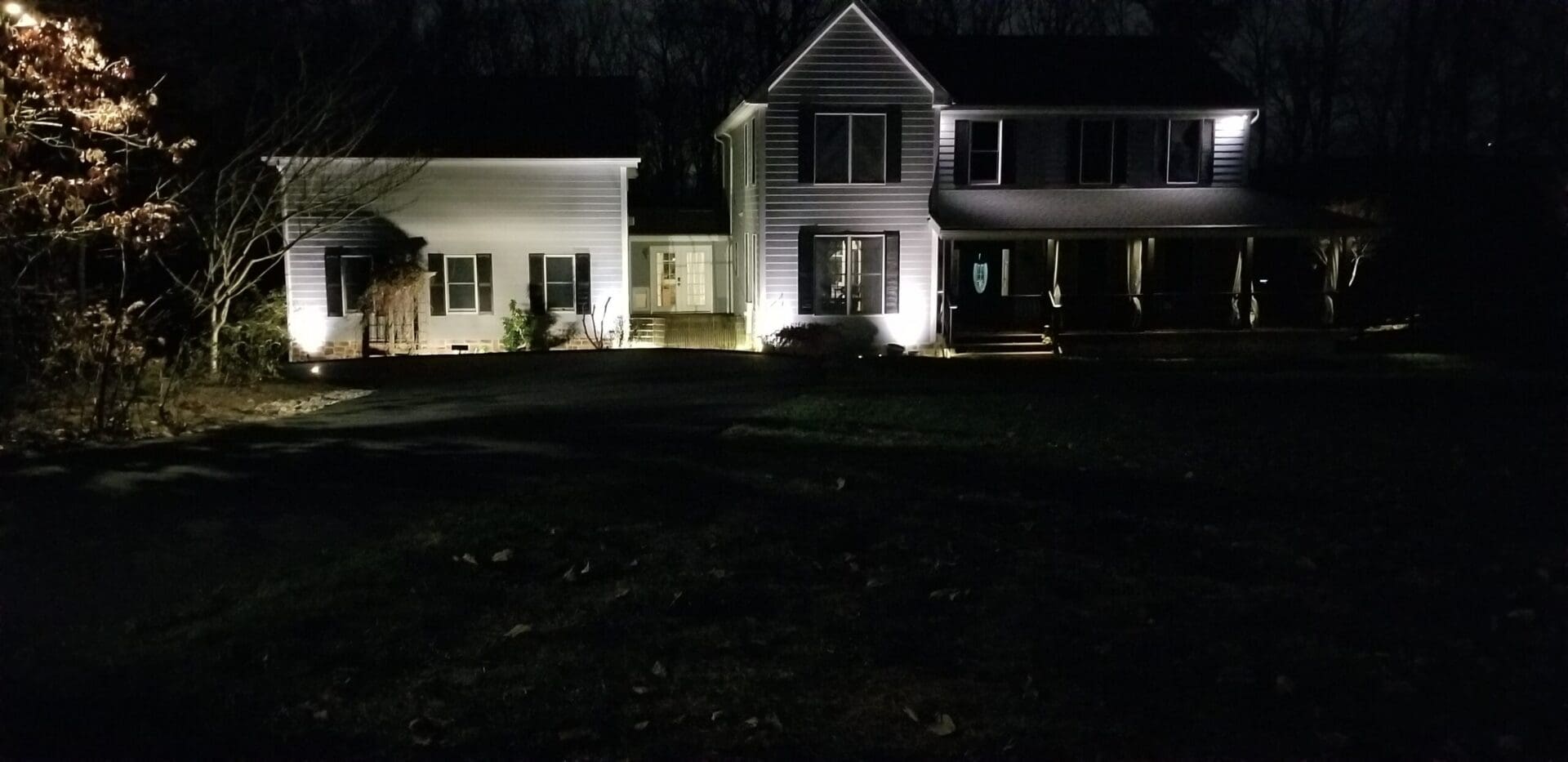 Large two-story house exterior illuminated at night