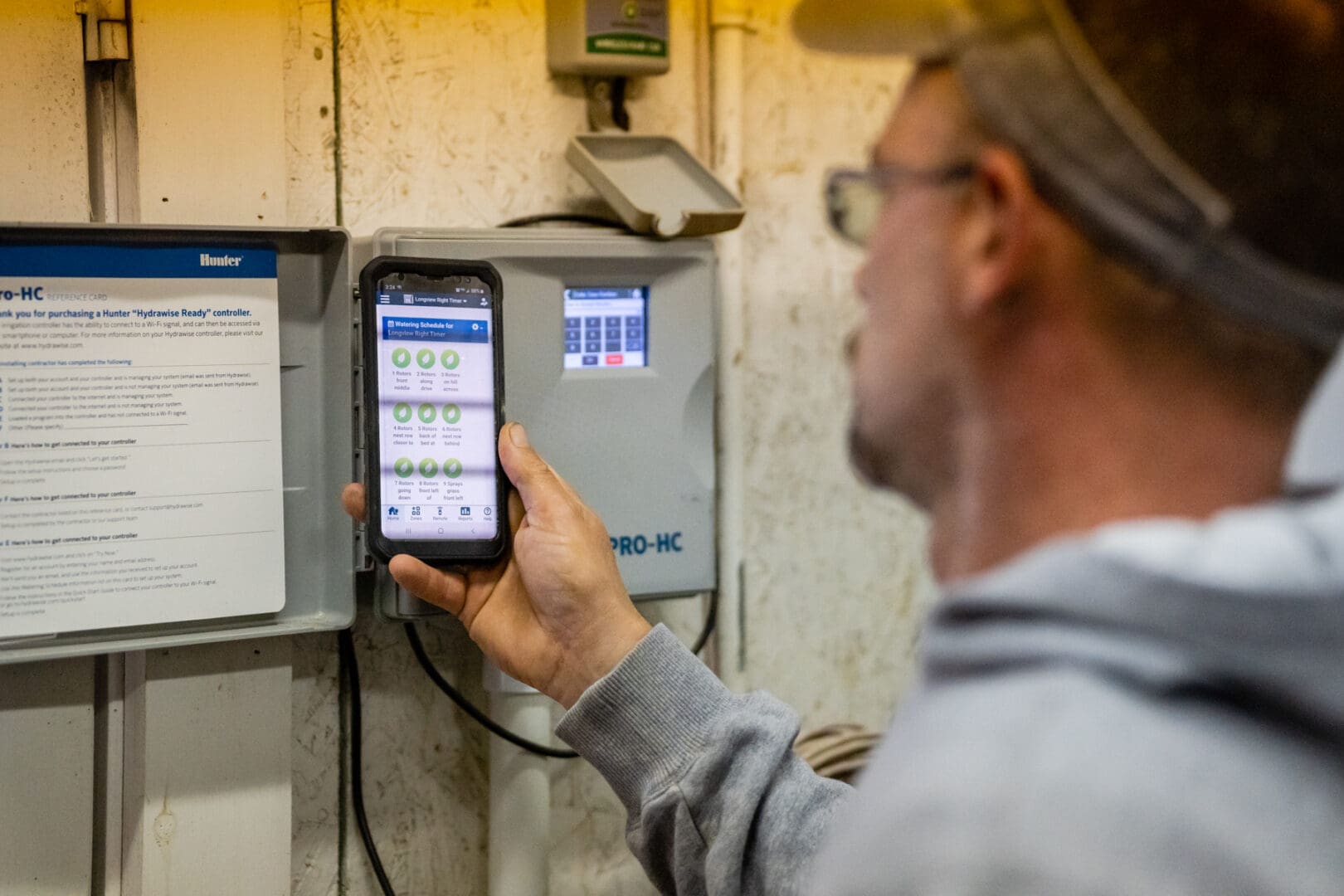 Person using smartphone to monitor control box