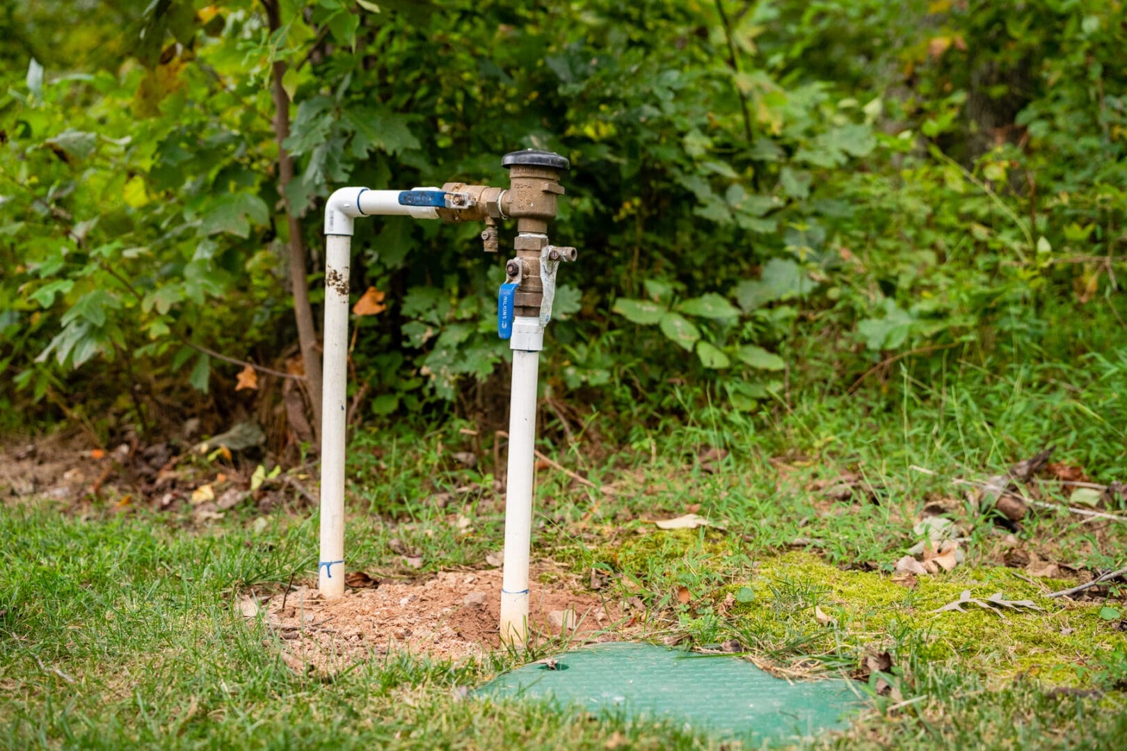 Backyard water spigot and exposed PVC pipes