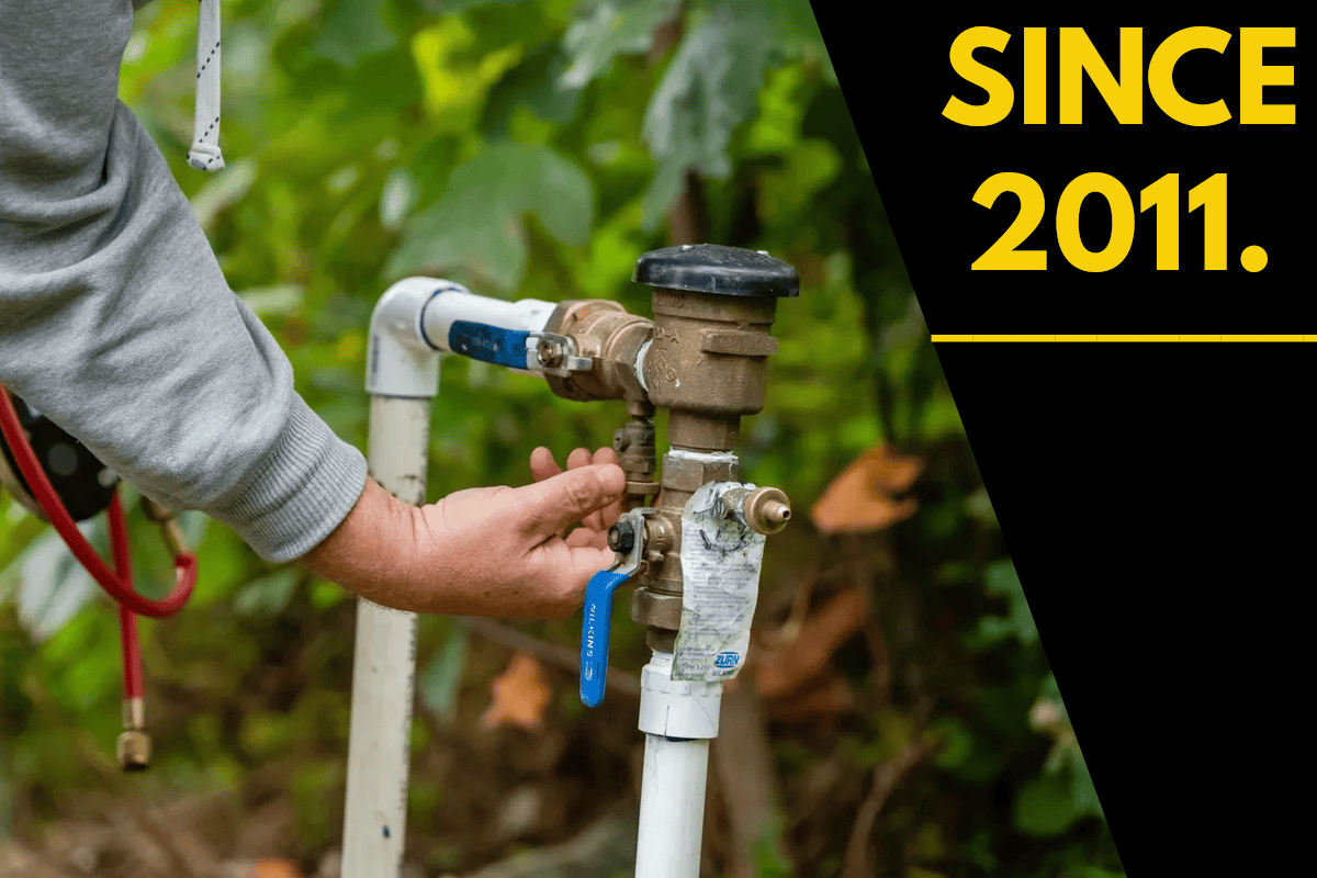 Hands turning outdoor water supply valve